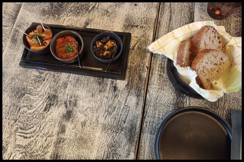 Three Portuguese starters at Culto ao Bacalhau: pickled carrots, tapenade with orange, tomato-chickpea salad